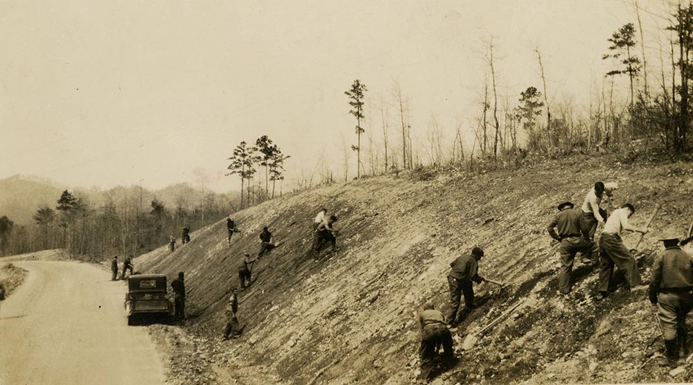 The Civilian Conservation Corps preparing a slope for seeding and planting