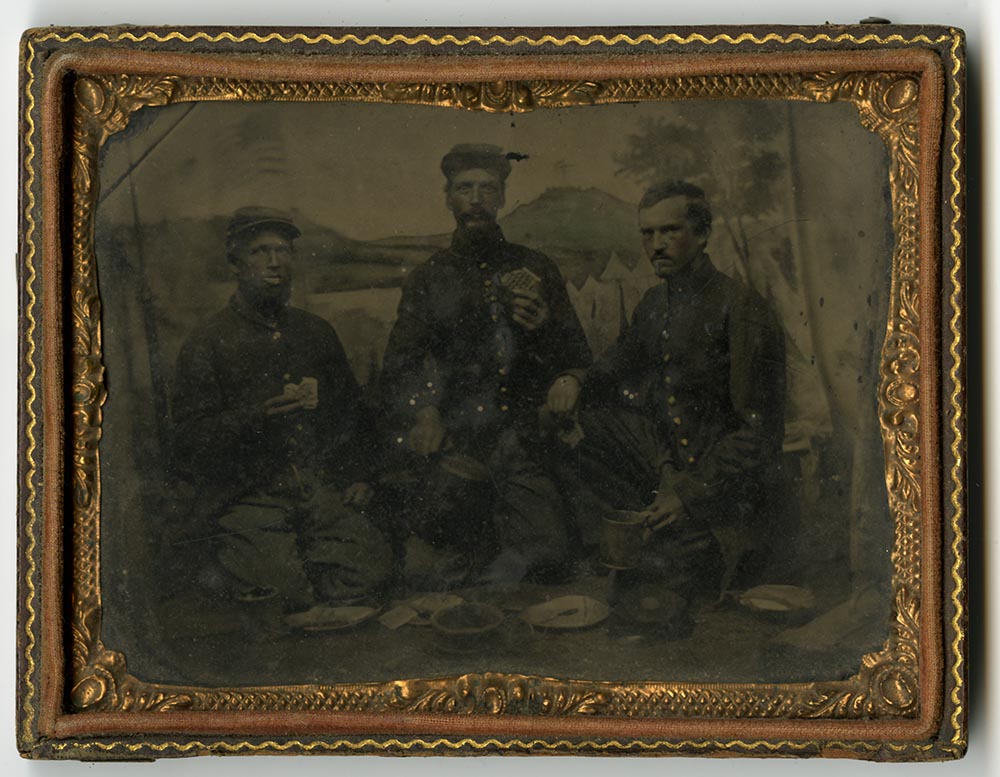 Tintype of Private Milo Stone and two soldiers eating hardtack